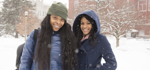 two friends standing in the snow